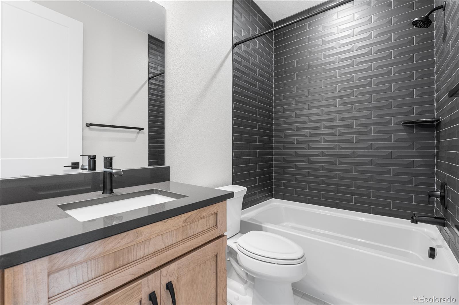 1250 Bridgefield Road Castle Pines, CO 80108 - Photo 21 of 33 a bathroom with a sink a toilet and shower