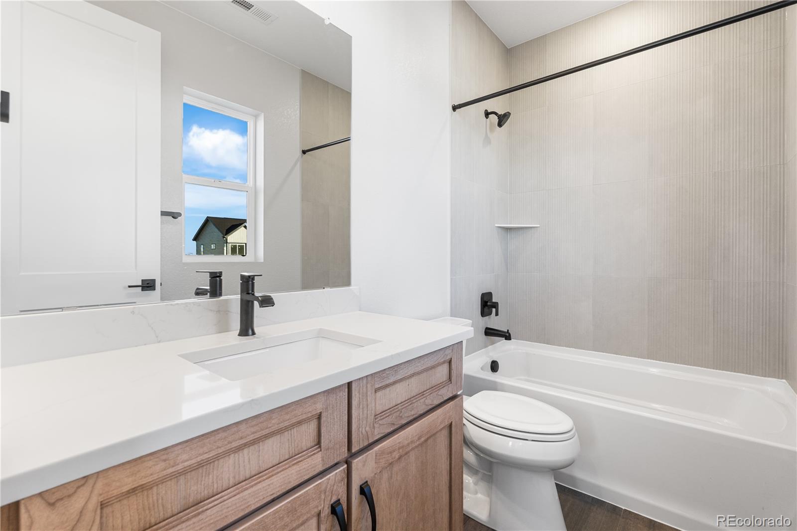 1250 Bridgefield Road Castle Pines, CO 80108 - Photo 22 of 33 a bathroom with a sink a toilet and a bathtub