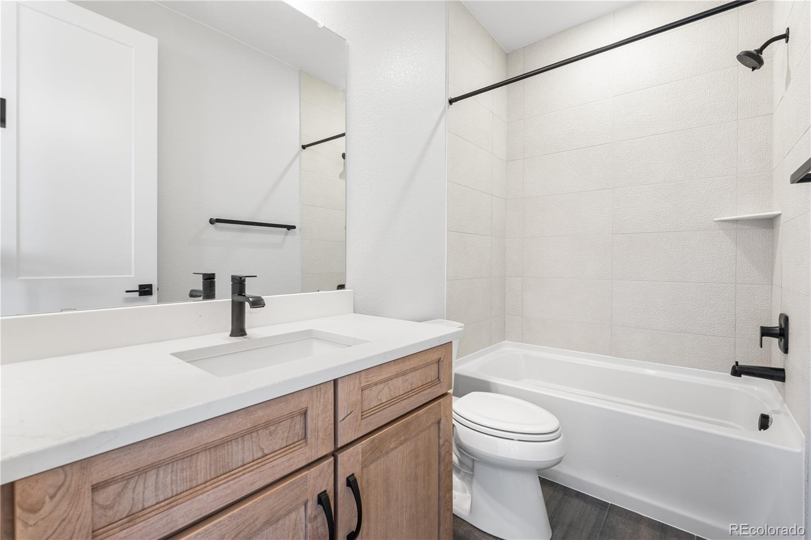 1250 Bridgefield Road Castle Pines, CO 80108 - Photo 23 of 33 a bathroom with a sink a toilet and a bathtub