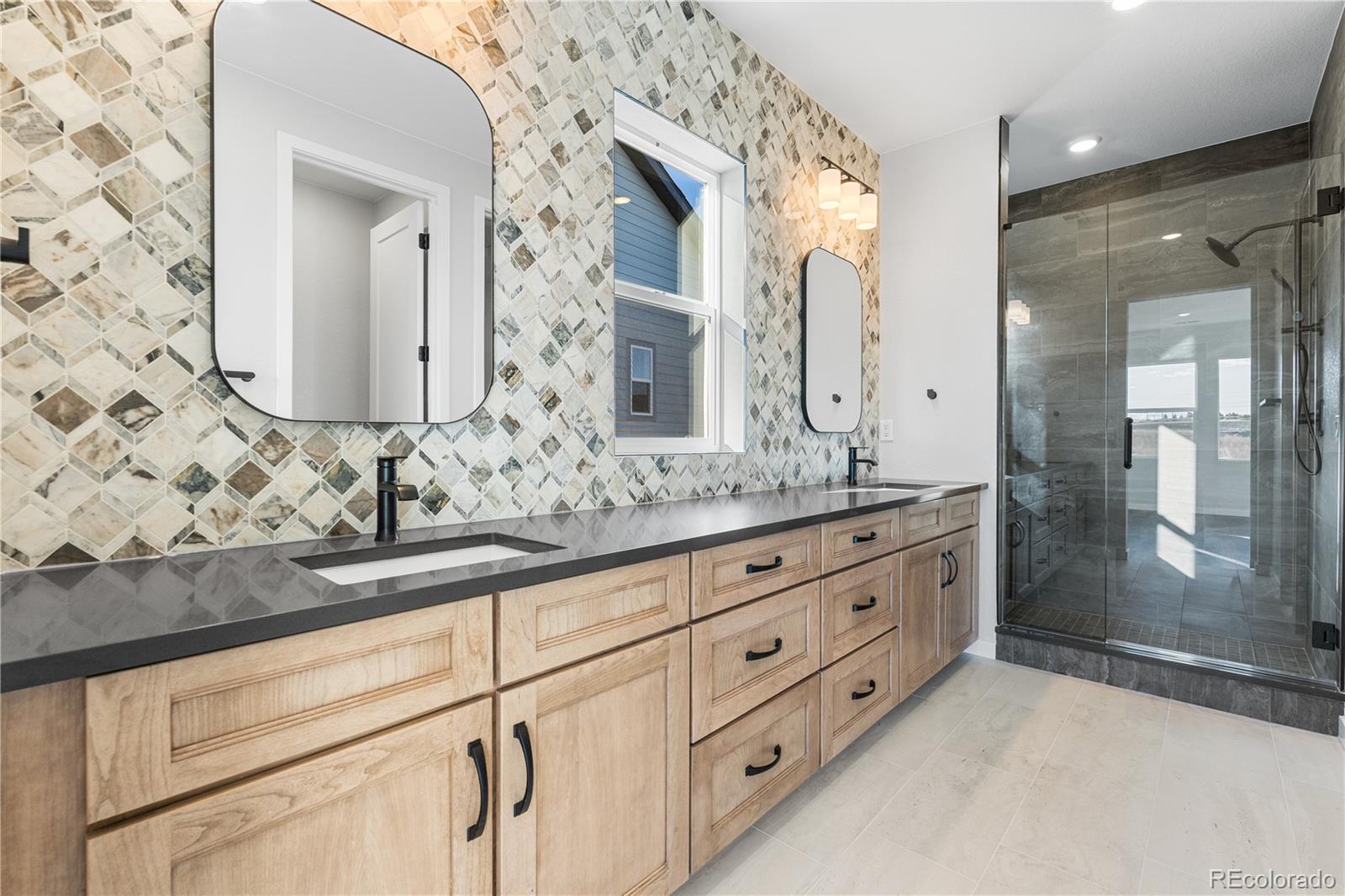 1250 Bridgefield Road Castle Pines, CO 80108 - Photo 26 of 33 a bathroom with double sink and a mirror