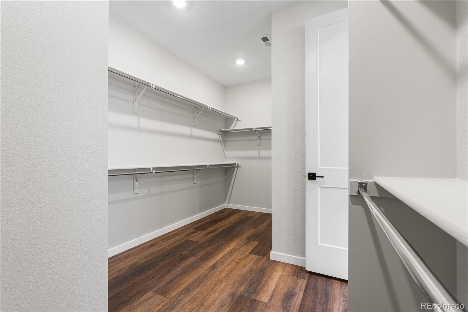 1250 Bridgefield Road Castle Pines, CO 80108 - Photo 30 of 33 a room with walk in closet and wooden floor