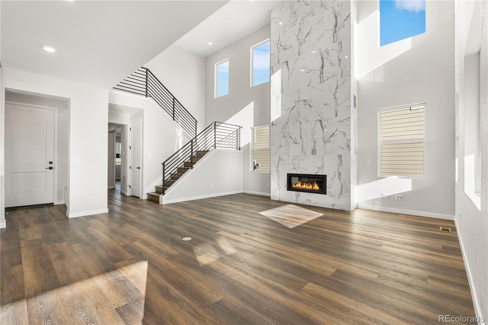 1250 Bridgefield Road Castle Pines, CO 80108 - Photo 5 of 33 a view of entryway and hall with wooden floor