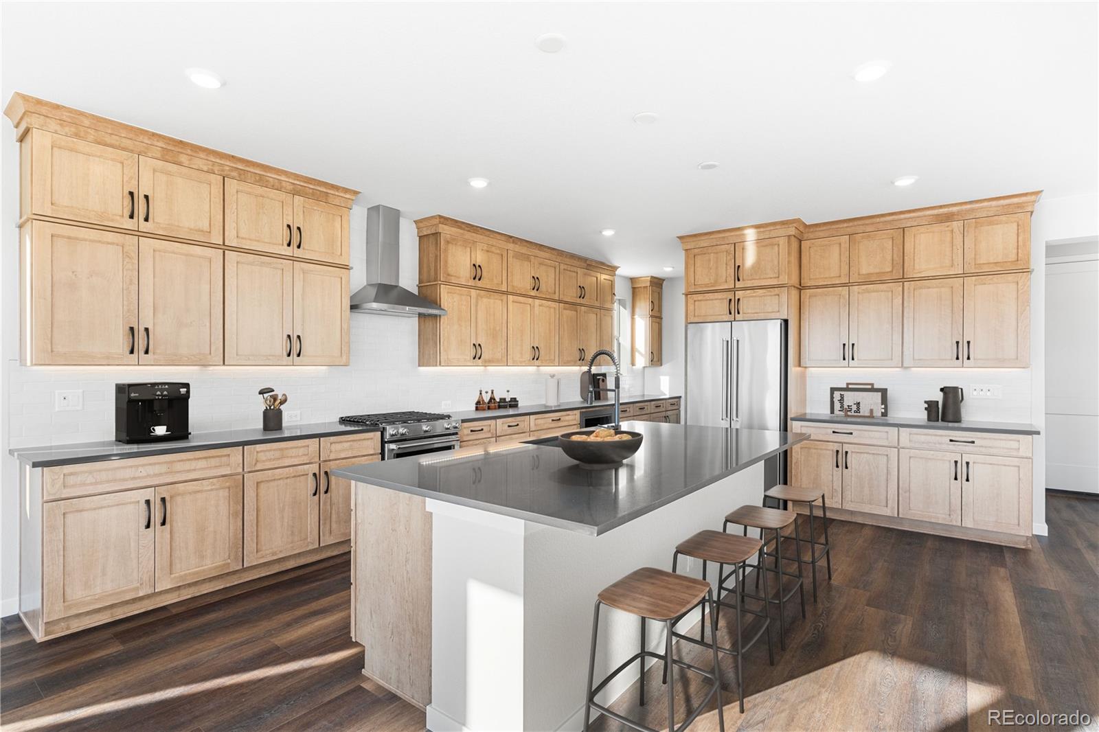 1250 Bridgefield Road Castle Pines, CO 80108 - Photo 8 of 33 a kitchen with white cabinets and white appliances