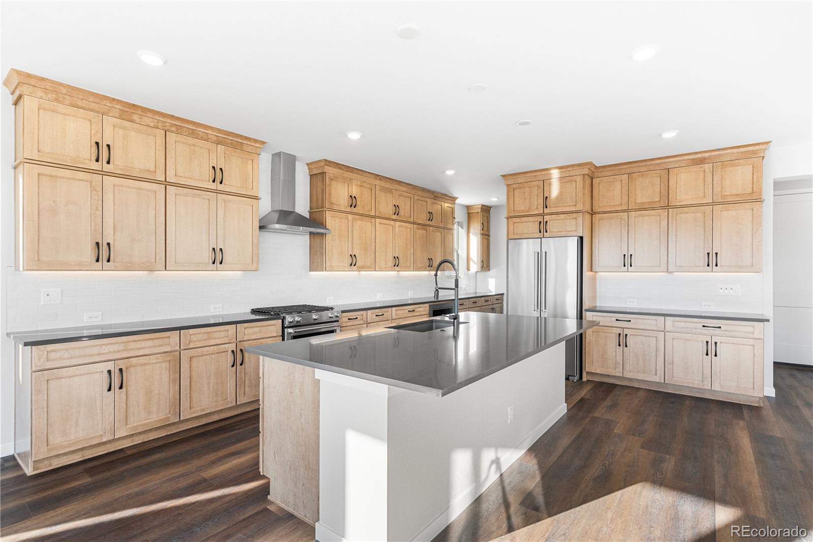 1250 Bridgefield Road Castle Pines, CO 80108 - Photo 9 of 33 a kitchen with cabinets a sink and appliances