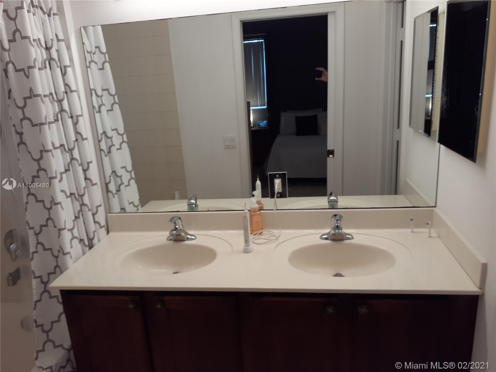 3011 Laurel Ridge Circle, Unit 3011 Riviera Beach, FL 33404 - Photo 8 of 15 a bathroom with a sink and a mirror