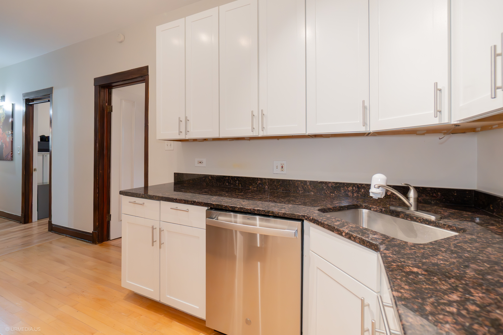 728 West Sheridan Road, Unit 1S Chicago, IL 60613 - Photo 10 of 19 a kitchen with granite countertop white cabinets and a sink
