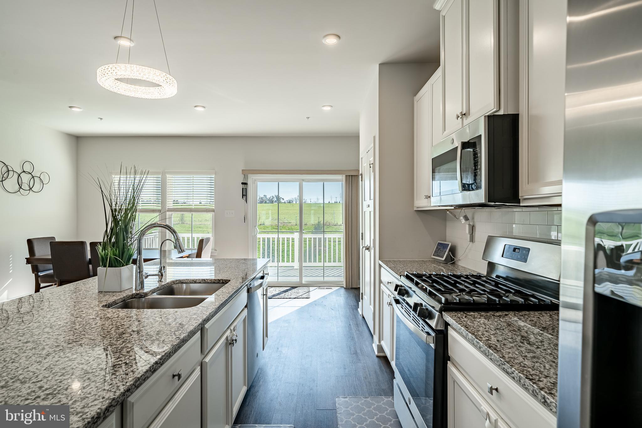 74 Glory Maple Lane Downingtown, PA 19335 - Photo 12 of 32 a kitchen with granite countertop a sink a counter top space appliances and cabinets