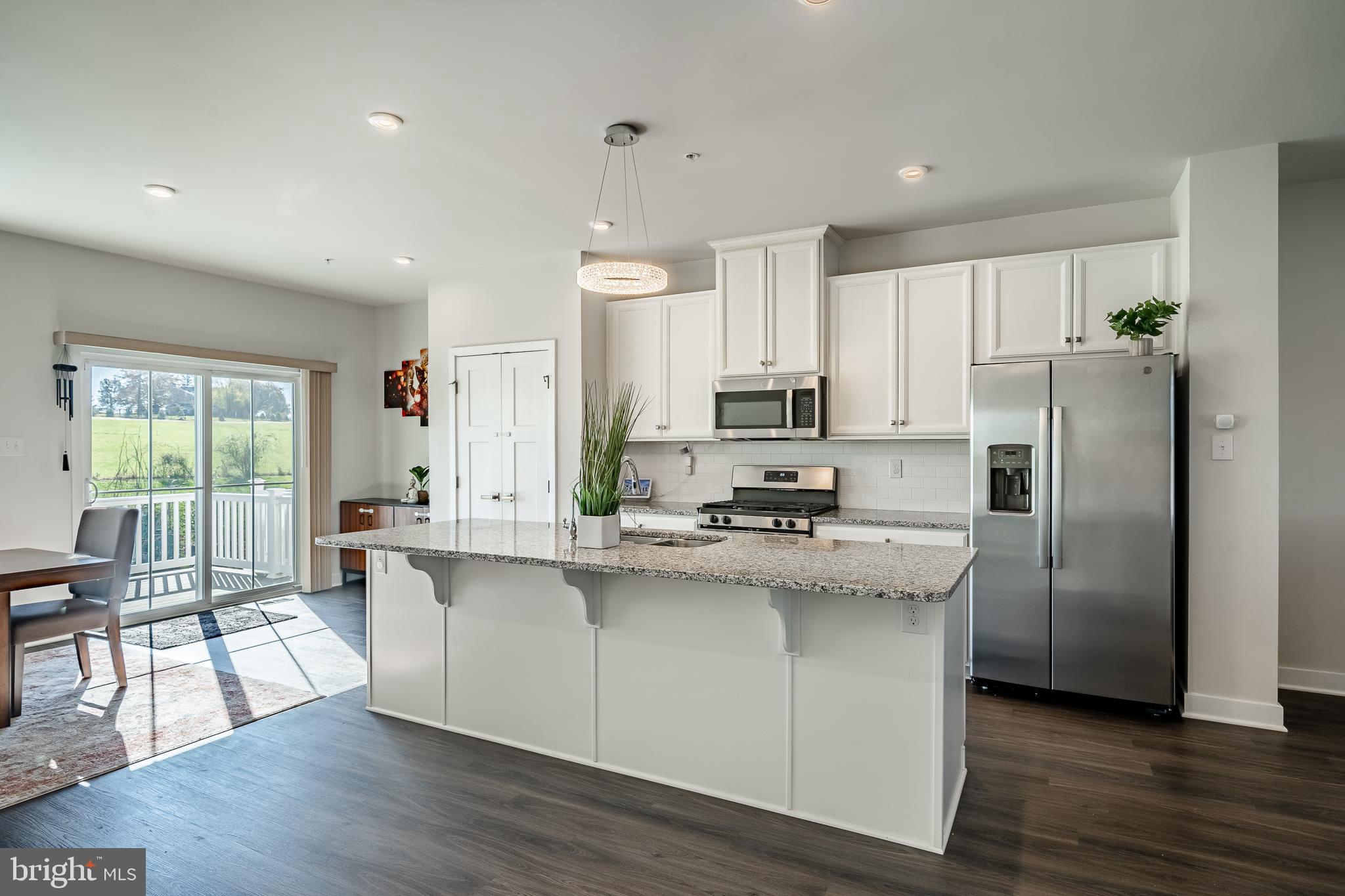 74 Glory Maple Lane Downingtown, PA 19335 - Photo 13 of 32 a kitchen with stainless steel appliances a sink a stove a refrigerator cabinets and wooden floor