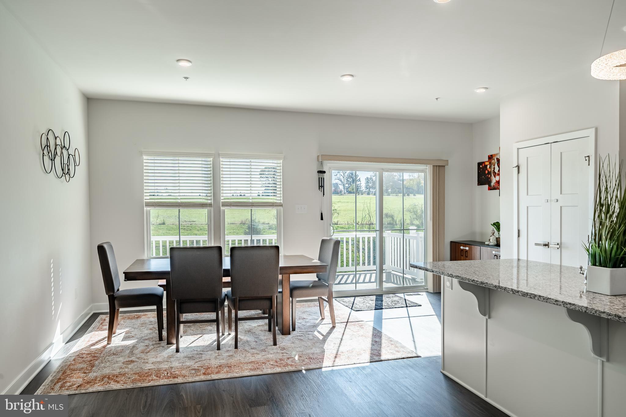 74 Glory Maple Lane Downingtown, PA 19335 - Photo 17 of 32 a dining room with wooden floor and floor to ceiling window