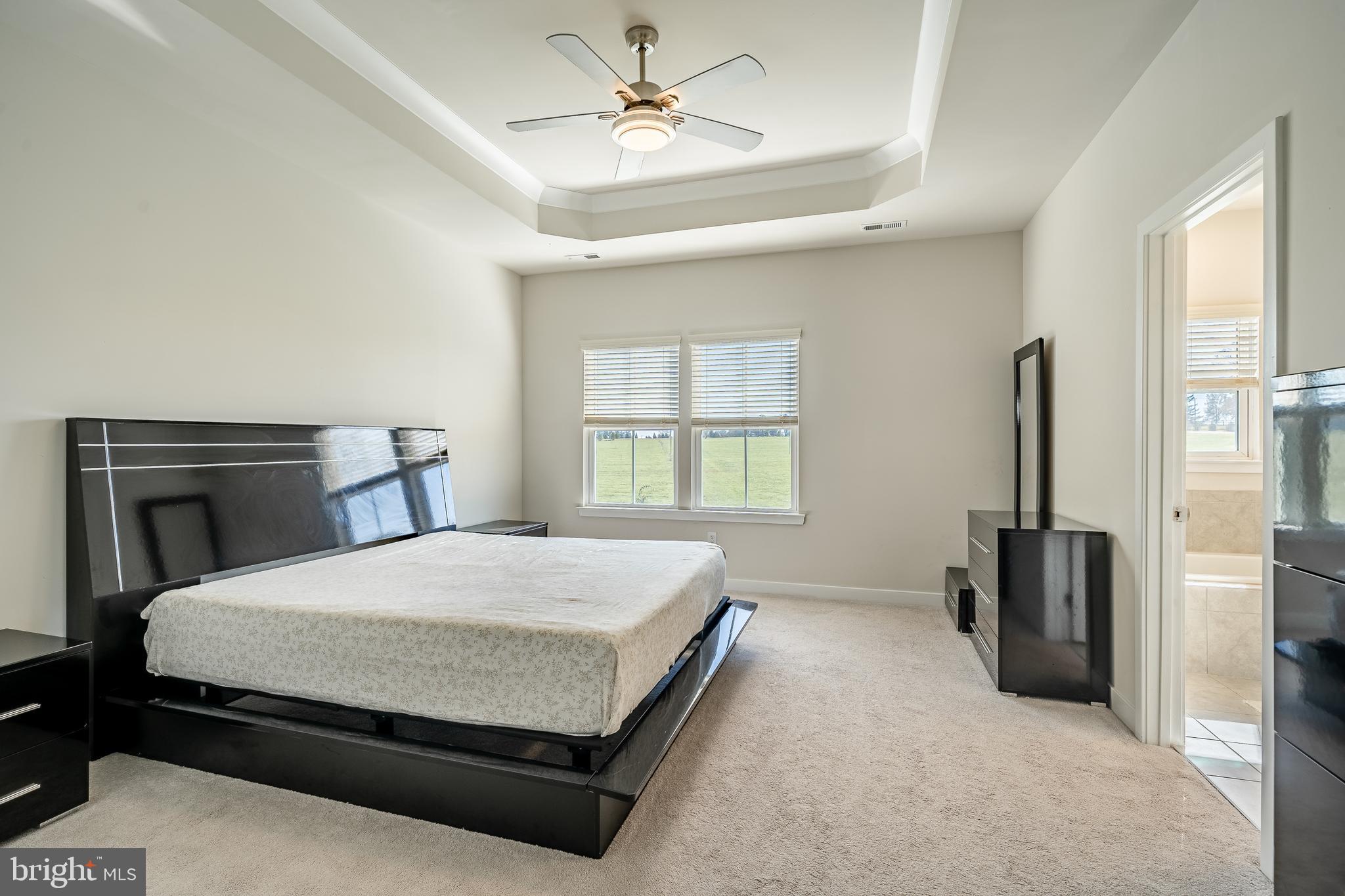 74 Glory Maple Lane Downingtown, PA 19335 - Photo 20 of 32 a bedroom with a bed and a chandelier