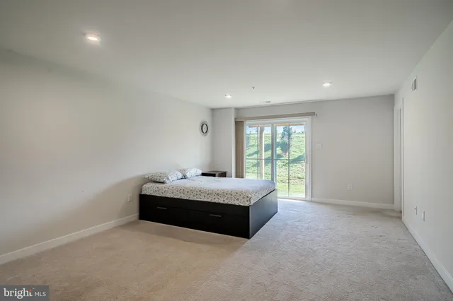 a spacious bedroom with a bed and window