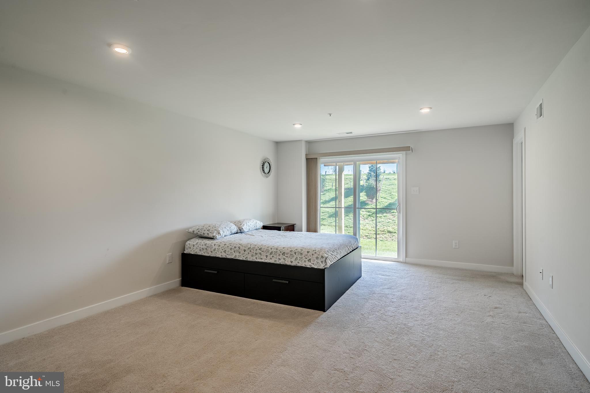 74 Glory Maple Lane Downingtown, PA 19335 - Photo 23 of 32 a spacious bedroom with a bed and window