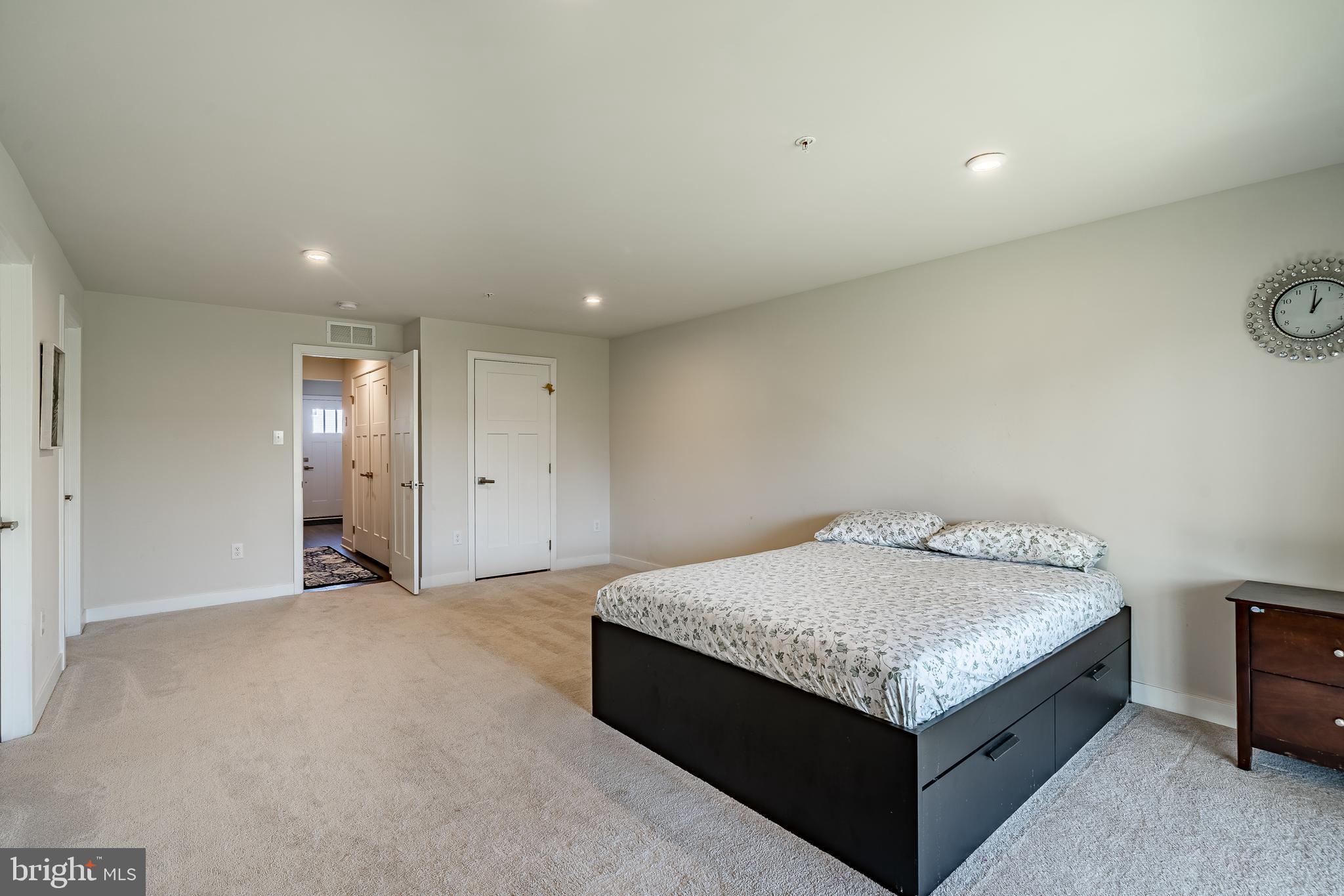 74 Glory Maple Lane Downingtown, PA 19335 - Photo 24 of 32 a room with a bed and a night stand