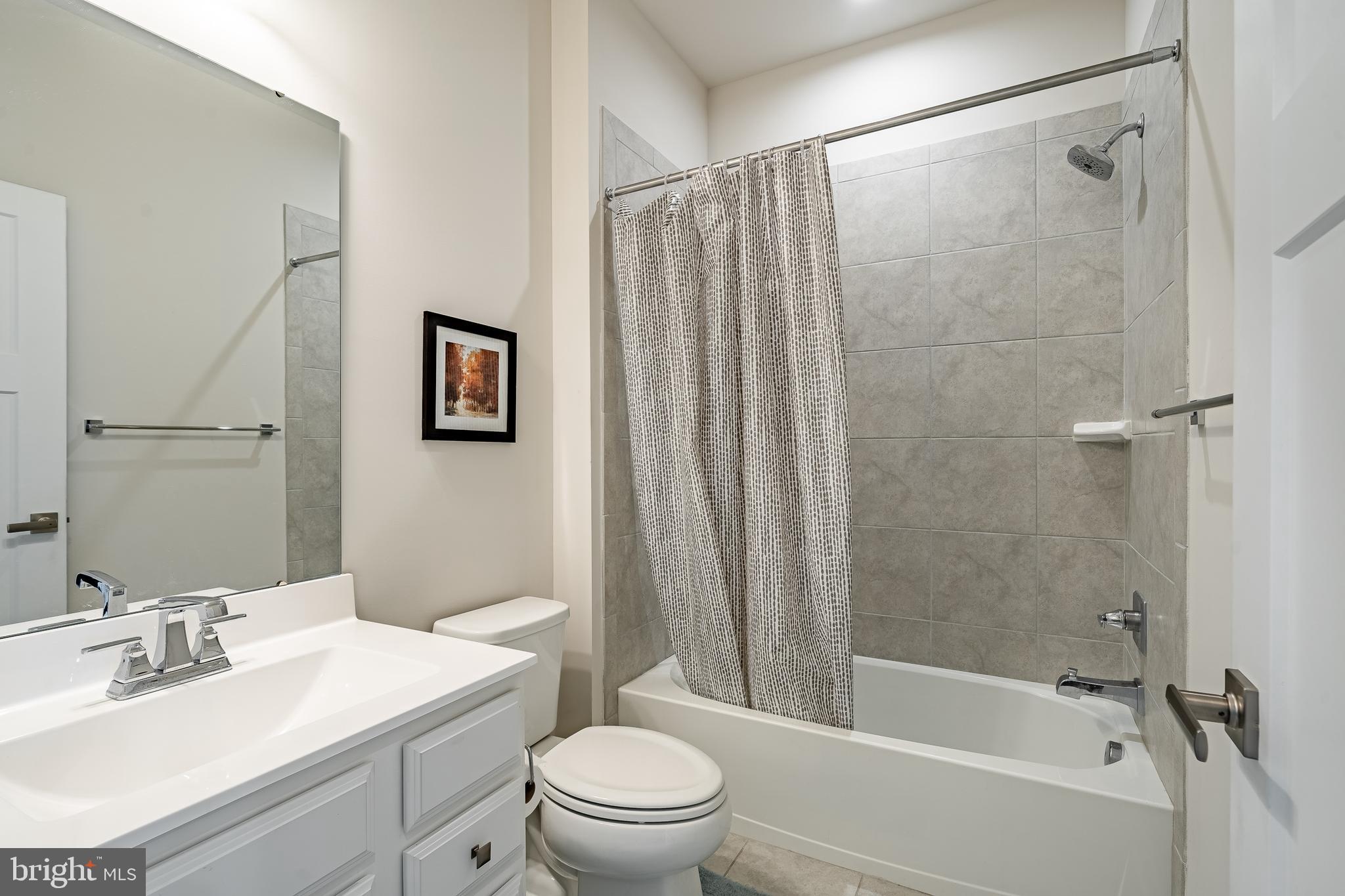 74 Glory Maple Lane Downingtown, PA 19335 - Photo 27 of 32 a bathroom with a sink a toilet and a mirror
