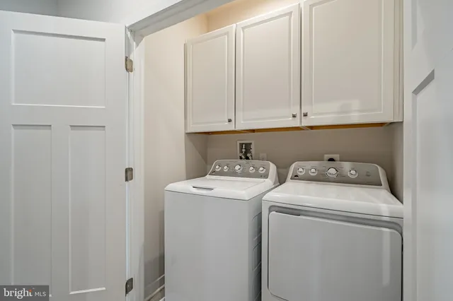 a view of storage and utility room with washer and dryer
