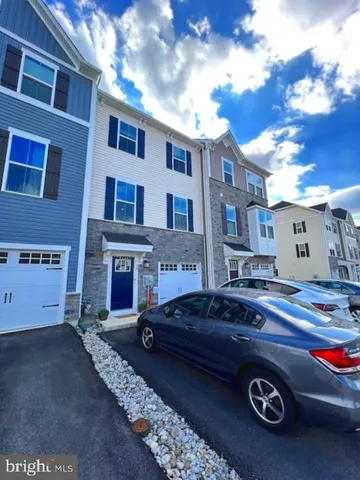 a front view of a house with parking space