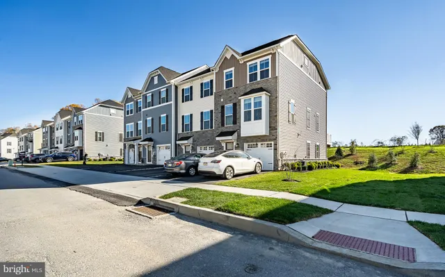 a front view of a residential apartment building with a yard
