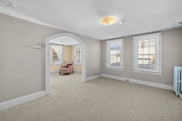 an empty room with furniture and a window