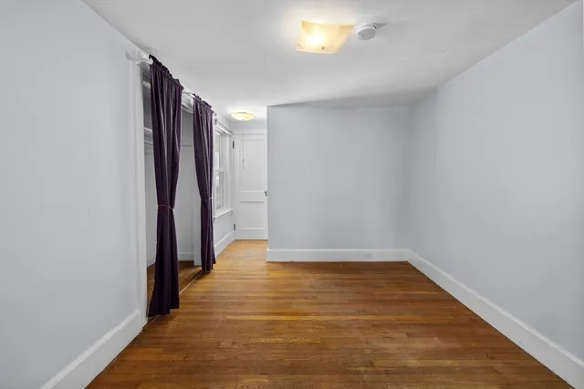 a view of hallway with wooden floor