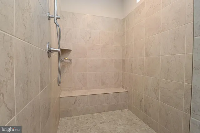 a spacious bedroom with a bed and a window