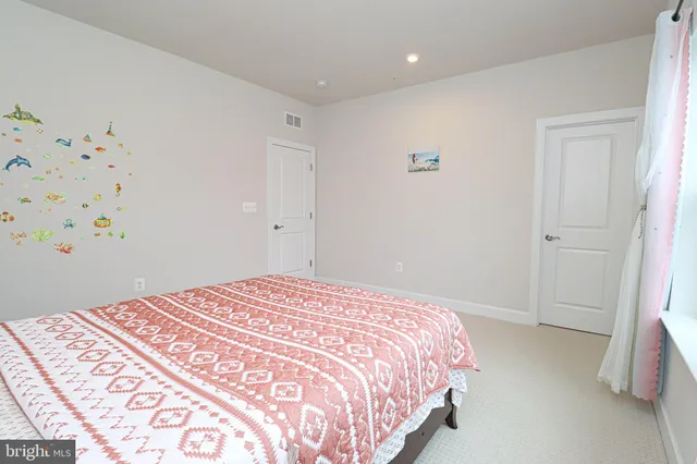a bathroom with a double vanity sink mirror and toilet
