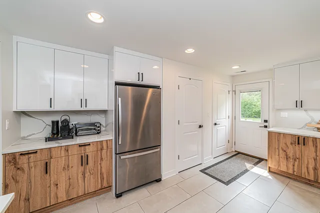 a kitchen with white cabinets and white appliances