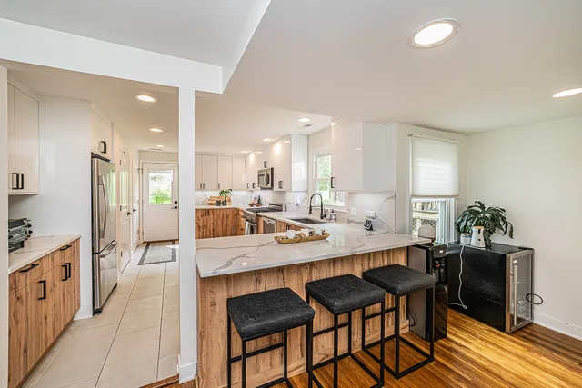 a large kitchen with a table and chairs