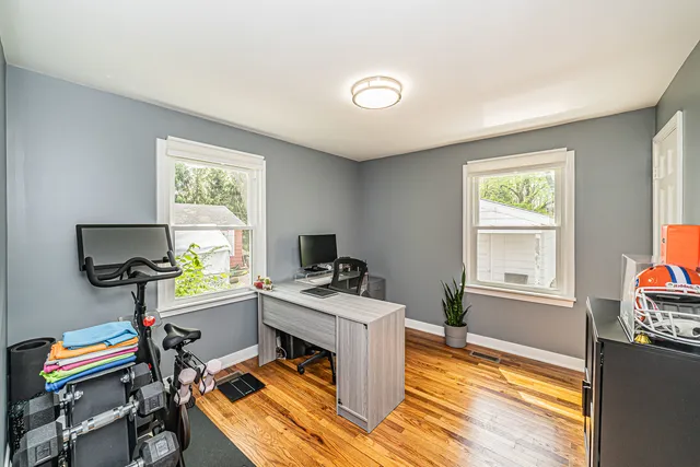a view of a workspace with furniture and a window