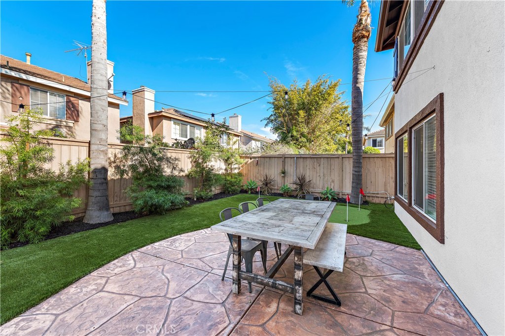 4314 Silver Spring Way Oceanside, CA 92057 - Photo 26 of 49 a view of a patio with table and chairs with wooden fence and plants