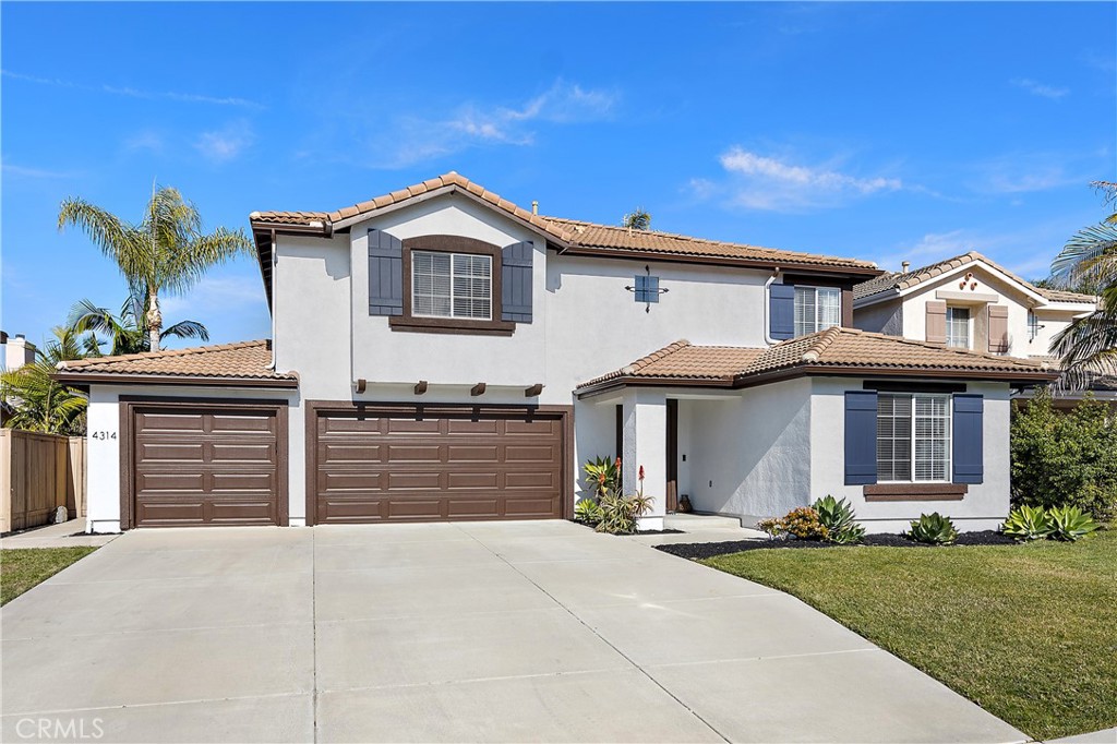 4314 Silver Spring Way Oceanside, CA 92057 - Photo 3 of 49 a front view of a house with a yard and garage