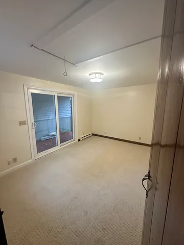 an empty room with windows and brick walls