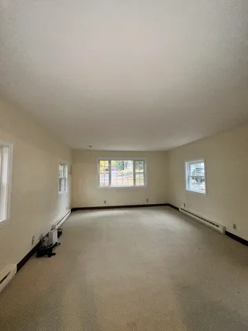an empty room with windows and closet
