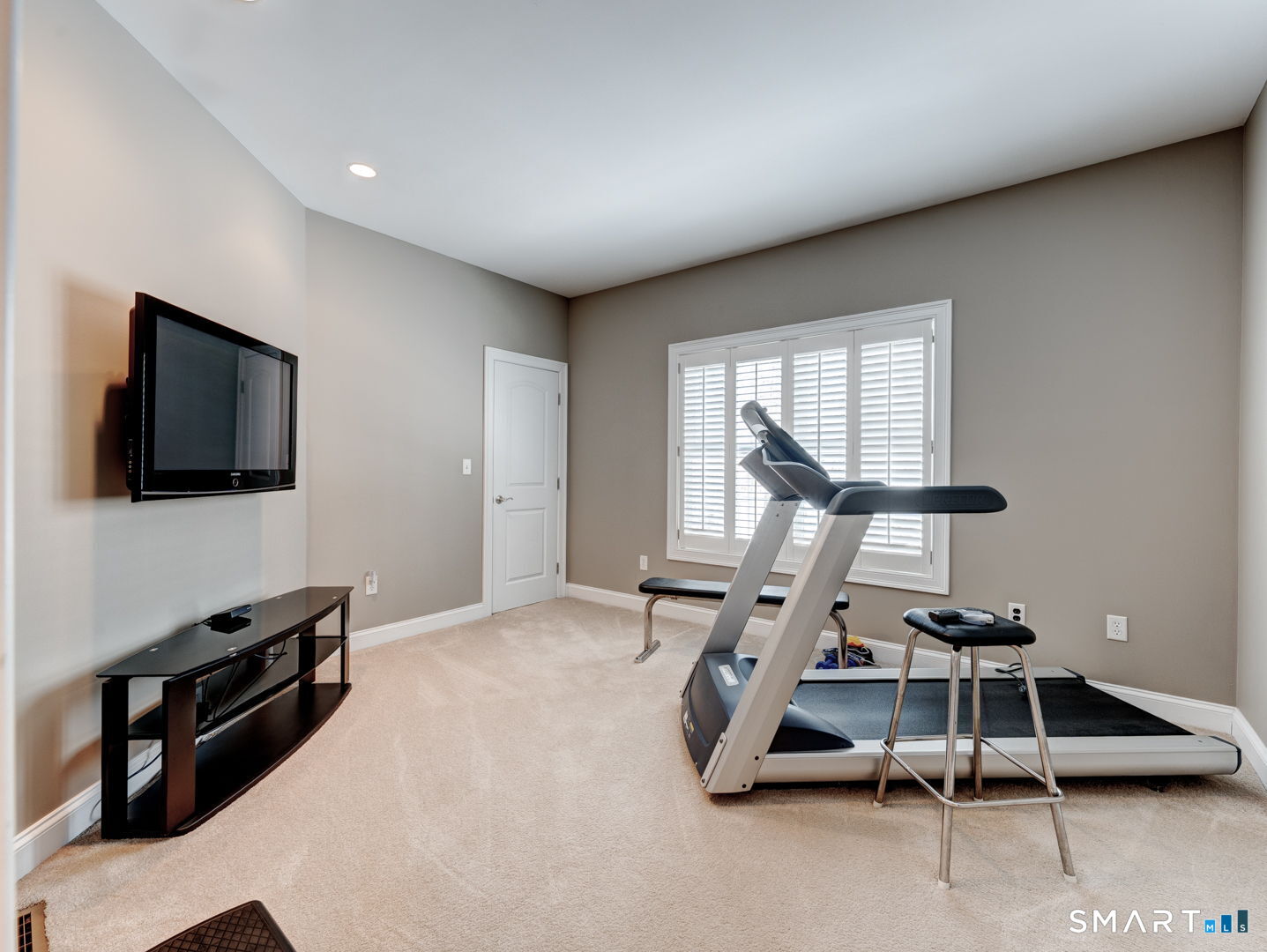 254 Sunset Ridge Rocky Hill, CT 06067 - Photo 25 of 40 a room with gym equipment and a flat screen tv