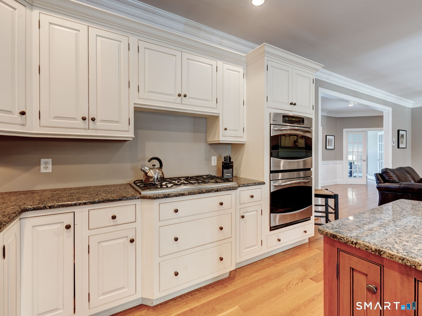 254 Sunset Ridge Rocky Hill, CT 06067 - Photo 9 of 40 a kitchen with granite countertop a stove a sink and dishwasher with white cabinets