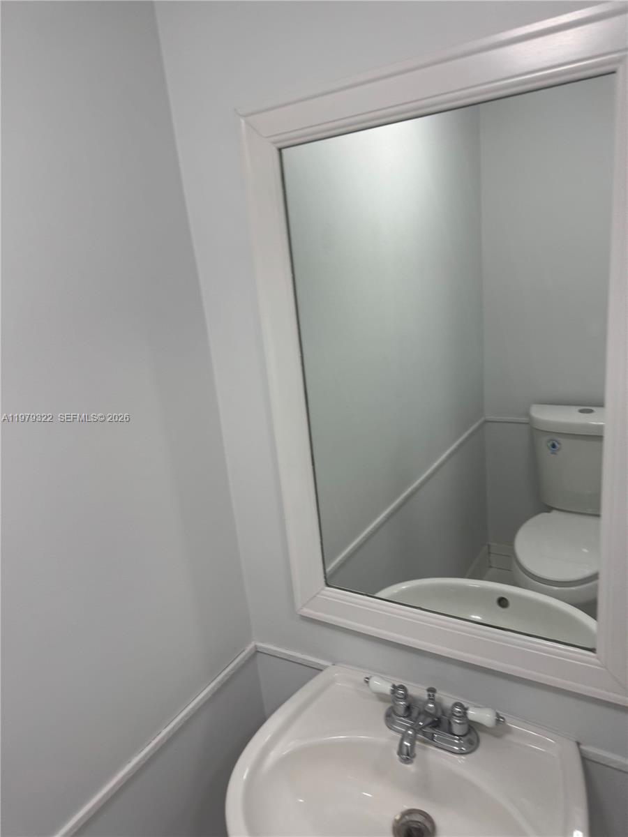 14909 Southwest 80th Street, Unit 216 Miami, FL 33193 - Photo 3 of 16 a bathroom with a sink and toilet