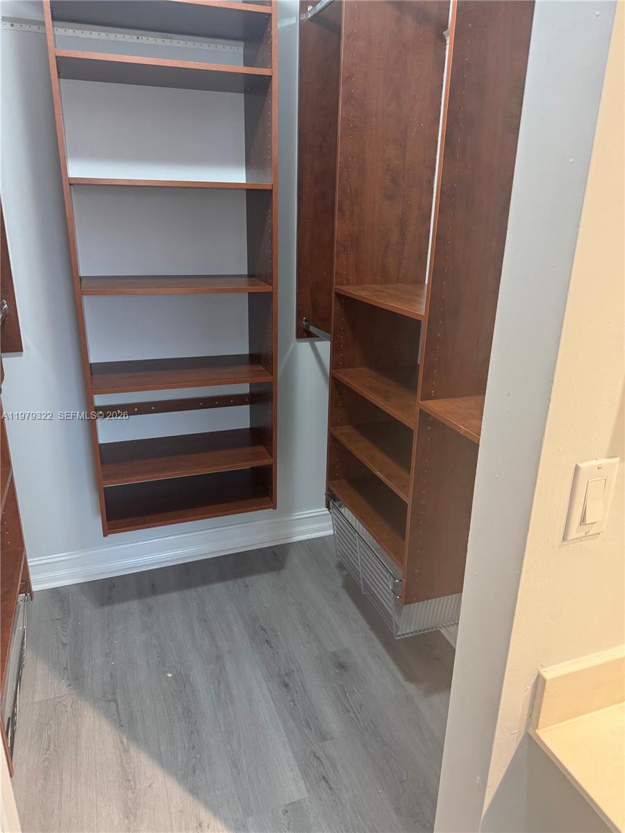 14909 Southwest 80th Street, Unit 216 Miami, FL 33193 - Photo 6 of 16 a view of walk in closet with empty racks