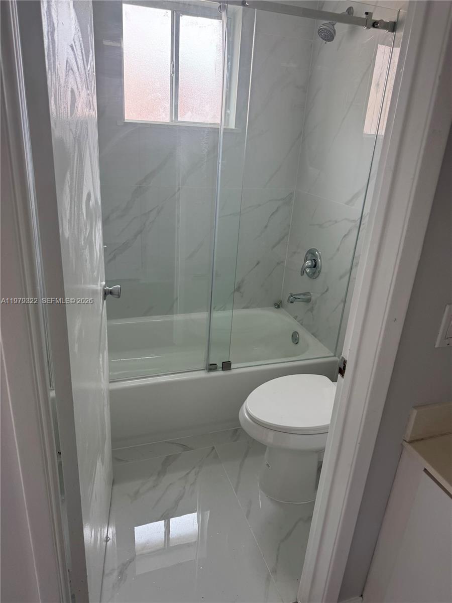 14909 Southwest 80th Street, Unit 216 Miami, FL 33193 - Photo 10 of 16 a bathroom with a toilet and a shower