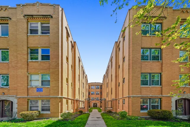 a view of a brick building next to a yard