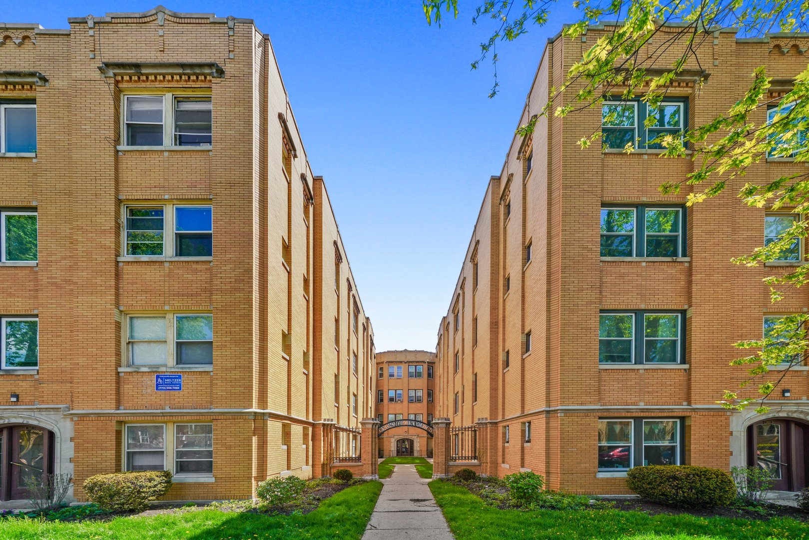 a view of a brick building next to a yard