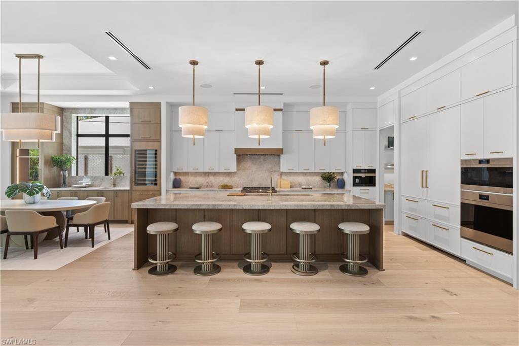 Luxurious kitchen with Sub-Zero and Wolf appliances, The Galley workstation sink, Taj Mahal and Cristallo quartzite countertops