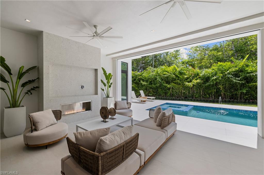 850 10th Street North Naples, FL 34102 - Photo 24 of 50 Lanai with roll down shutters and screens, fireplace
