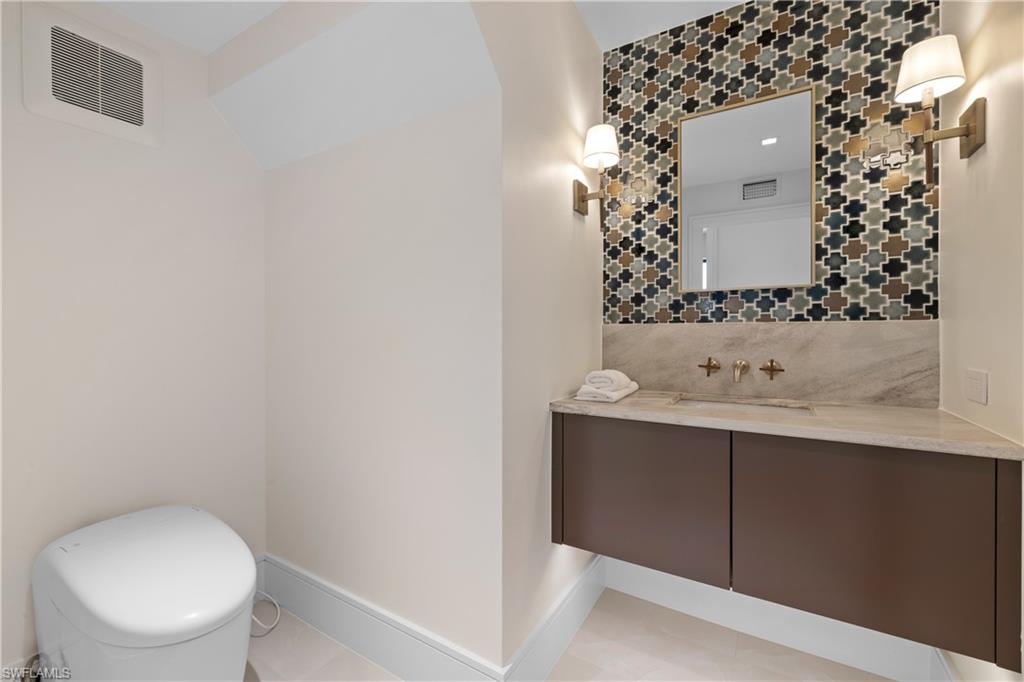 850 10th Street North Naples, FL 34102 - Photo 45 of 50 Powder room with TOTO “Neorest” Toilet,Encore Ceramics Mosaic York Custom Tile