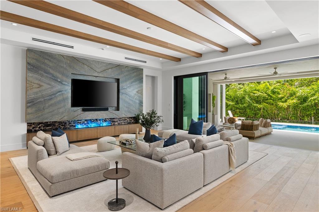 850 10th Street North Naples, FL 34102 - Photo 7 of 50 The showpiece great room is anchored by an Ocean Blue quartzite feature wall