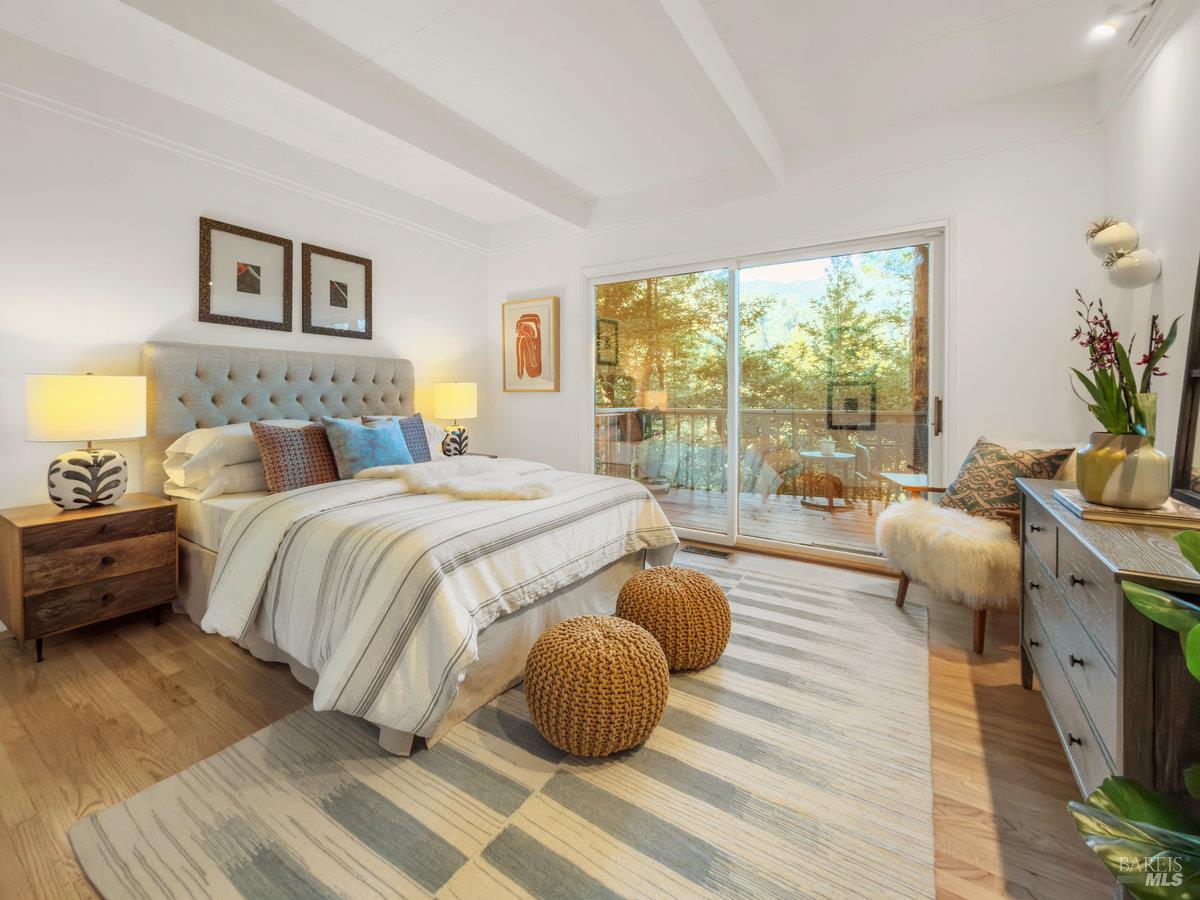300 Hazel Avenue Mill Valley, CA 94941 - Photo 14 of 50 a bedroom with a bed and wooden floor