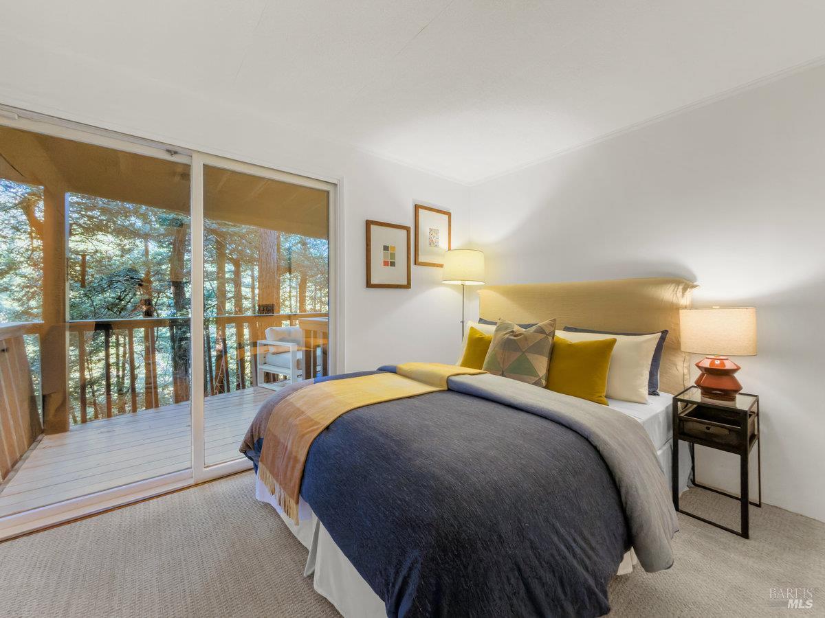 300 Hazel Avenue Mill Valley, CA 94941 - Photo 28 of 50 a bedroom with a bed and a lamp next to a window