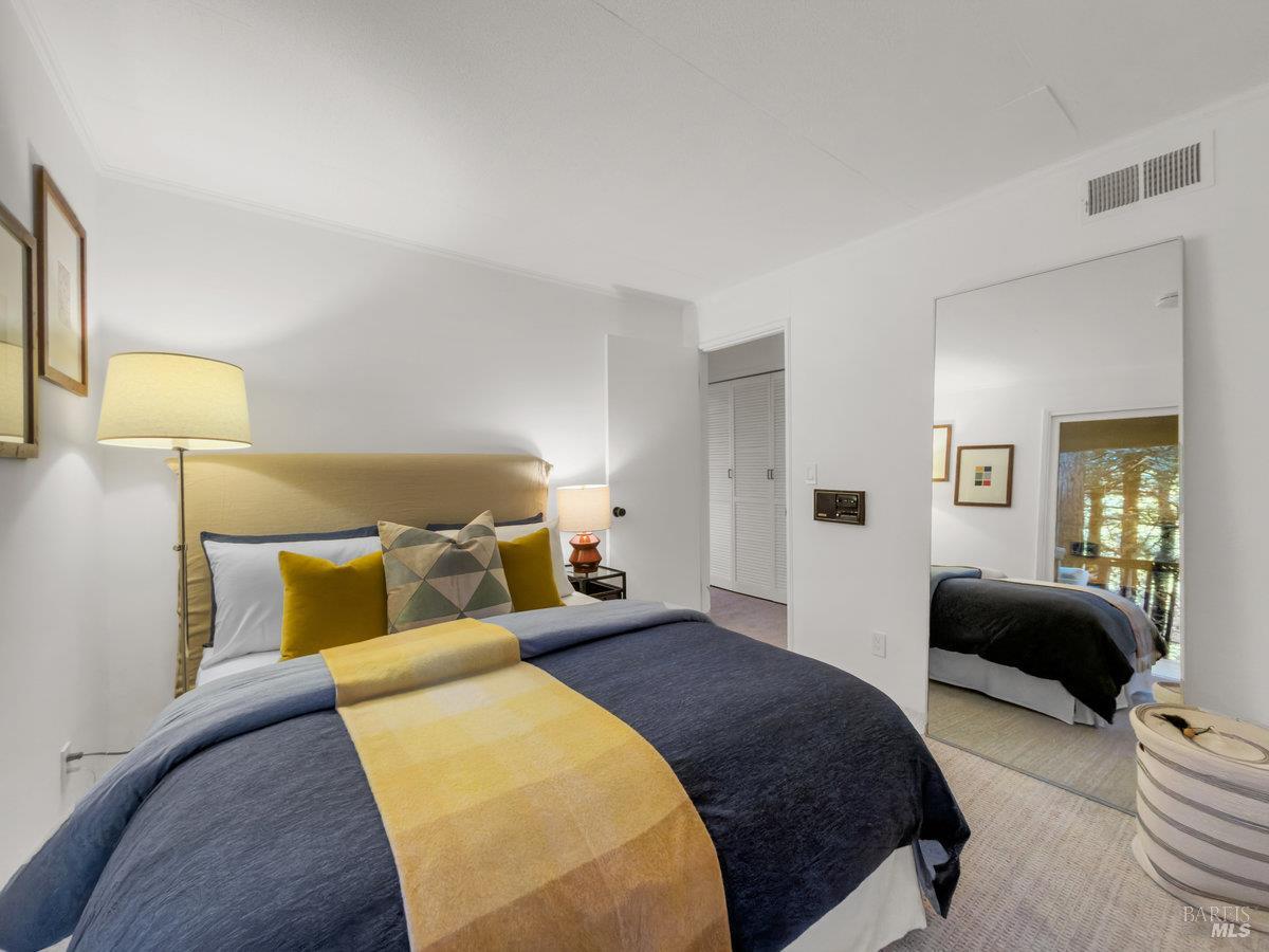 300 Hazel Avenue Mill Valley, CA 94941 - Photo 29 of 50 a bedroom with a bed a couch and a lamp on dresser