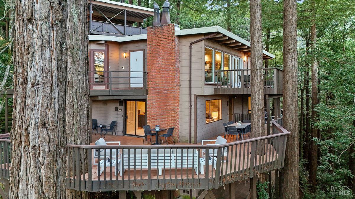 300 Hazel Avenue Mill Valley, CA 94941 - Photo 45 of 50 a view of a brick house with large windows and a table and chairs