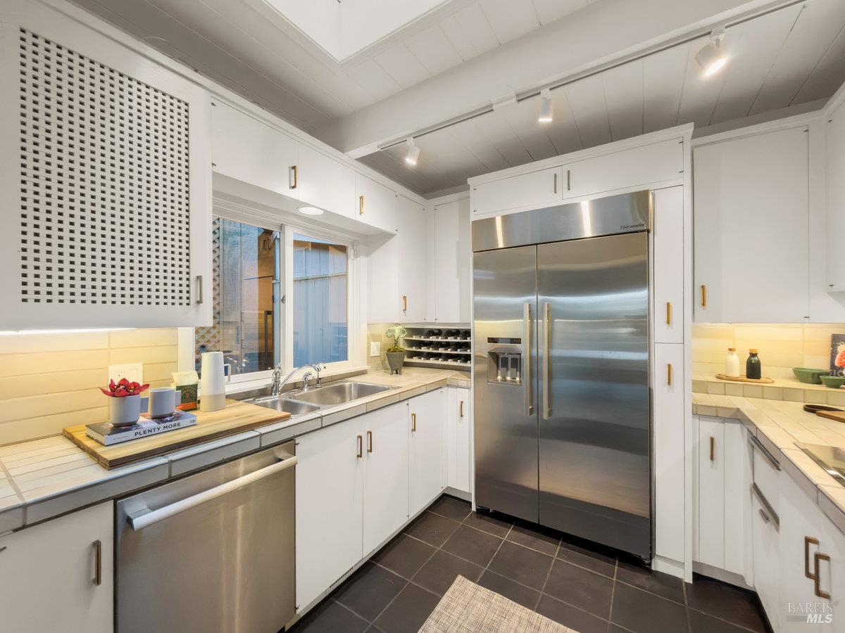 300 Hazel Avenue Mill Valley, CA 94941 - Photo 10 of 50 a kitchen with a sink stainless steel appliances and cabinets