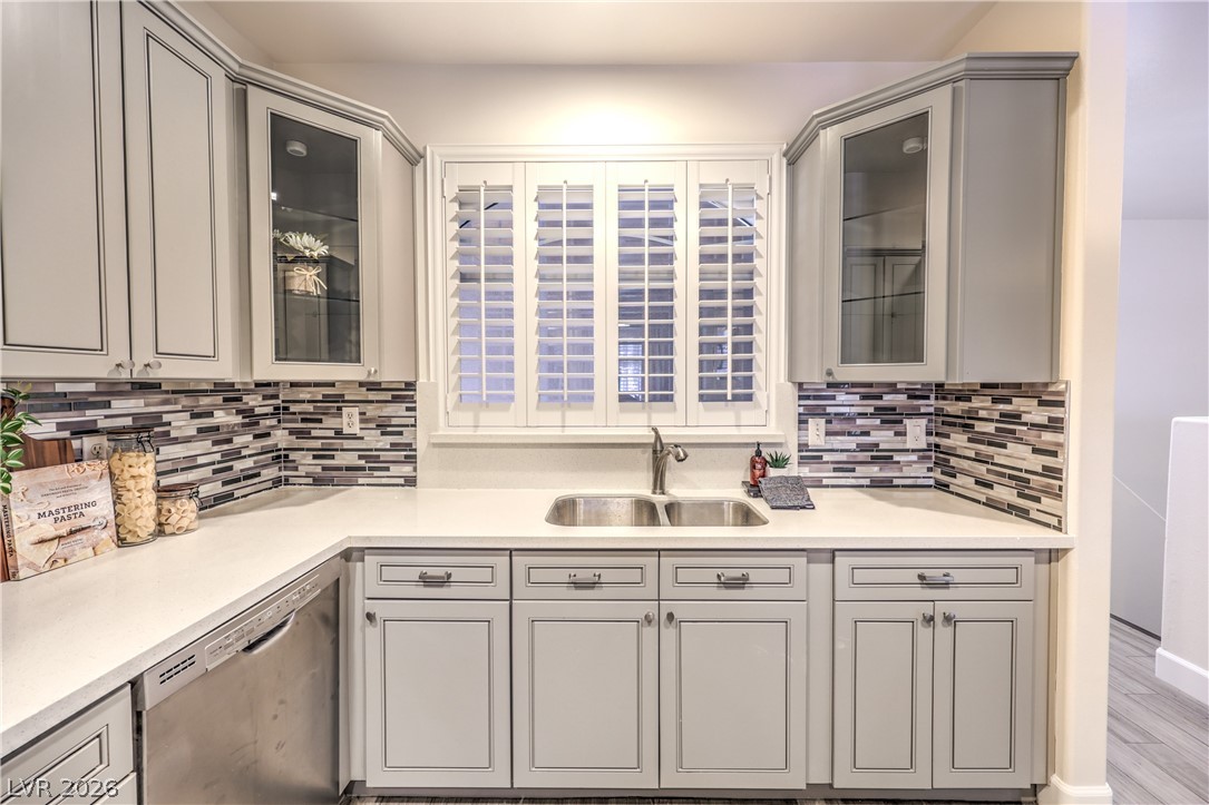2050 West Warm Springs Road, Unit 1421 Henderson, NV 89014 - Photo 17 of 45 A well-appointed kitchen features sleek countertops, stylish cabinetry, and a dual basin sink beneath a window.