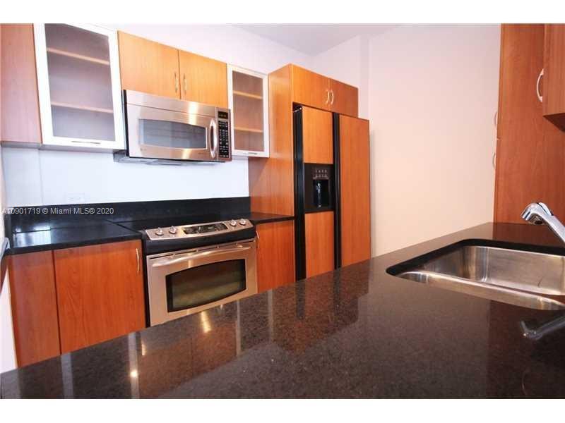 a kitchen with stainless steel appliances granite countertop a sink and a granite counter tops